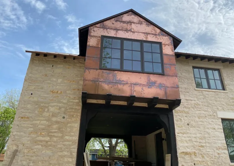 Copper metal panel facade on a stone building for Roof Repair in Hickory Hills