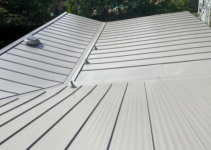 Solar attic fan installed on a metal roof for Roof Ventilation in Hickory Hills